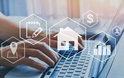 Owner builder planning with house and dollar symbol on a keyboard, representing financial planning for building.